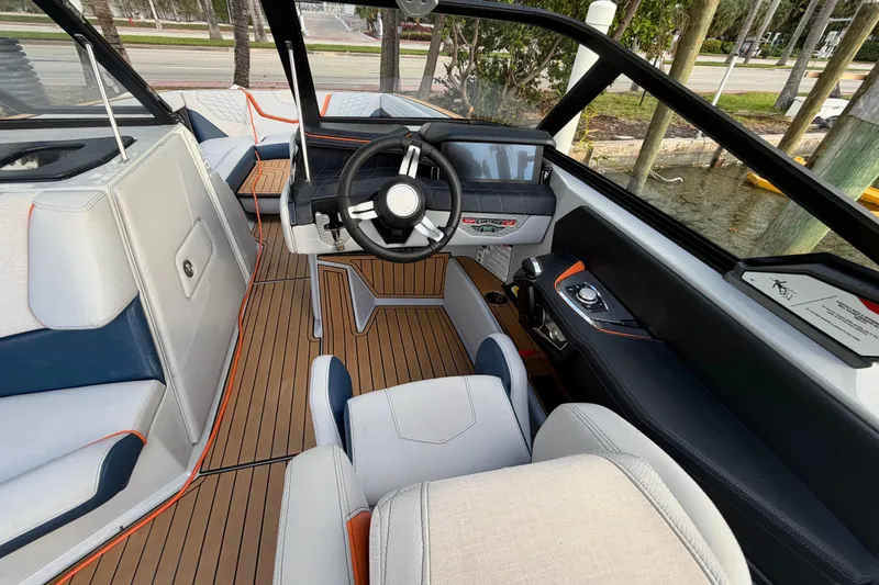 Slide: The Image of 2022 Nautique Super Air Nautique G25 boat with sleek interior and advanced sound system. - 12