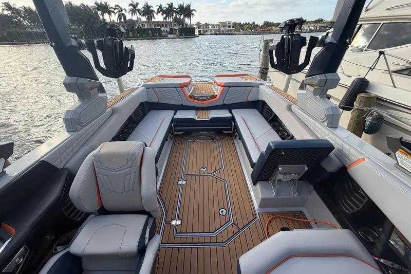 Slide: The Image of 2022 Nautique Super Air Nautique G25 boat interior with spacious seating and modern design. - 9