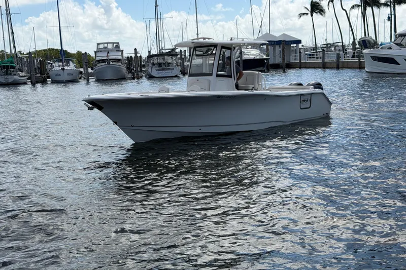 The Image of 2022 Sea Hunt Ultra 275 SE boat docked in a marina with sailboats. - 0