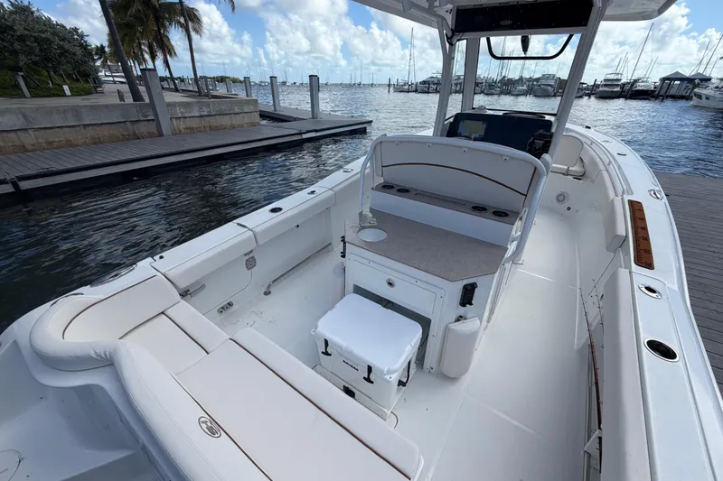 Slide: The Image of 2022 Sea Hunt Ultra 275 SE boat docked, featuring spacious seating and modern amenities. - 17