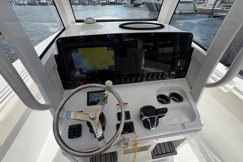 Slide: The Image of 2022 Sea Hunt Ultra 275 SE boat dashboard with steering wheel and navigation display. - 29
