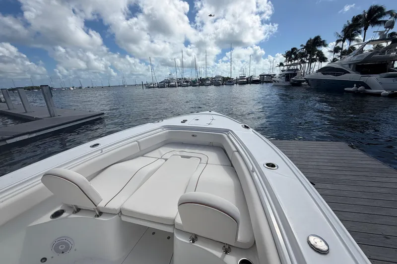 Slide: The Image of 2022 Sea Hunt Ultra 275 SE boat docked at marina with clear skies. - 33