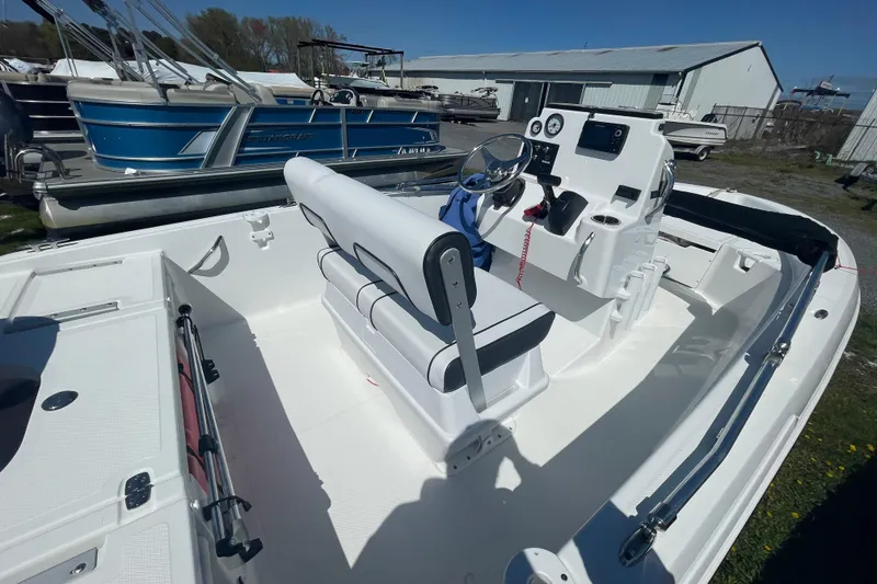 Slide: The Image of 2021 Wellcraft 162 Fisherman boat interior with steering console and seating. - 2