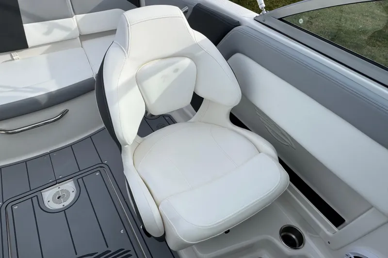 Slide: The Image of 2026 Chaparral 19 SSi OB boat interior with white seating and gray flooring. - 11