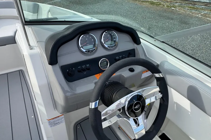 Slide: The Image of 2026 Chaparral 19 SSi OB boat dashboard with steering wheel and gauges. - 12