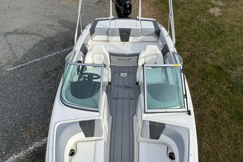 Slide: The Image of 2026 Chaparral 19 SSi OB boat interior with seating and steering wheel, viewed from above. - 13