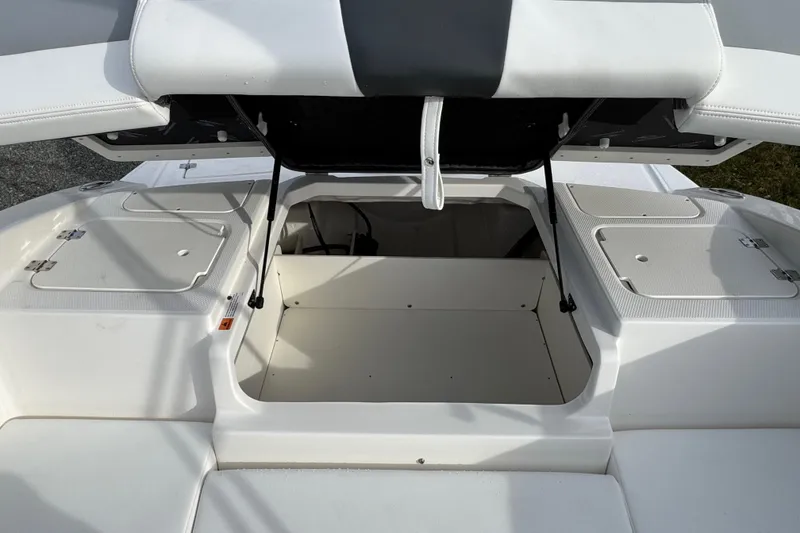 Slide: The Image of Open storage compartment on 2026 Chaparral 19 SSi OB boat, showcasing ample space. - 6