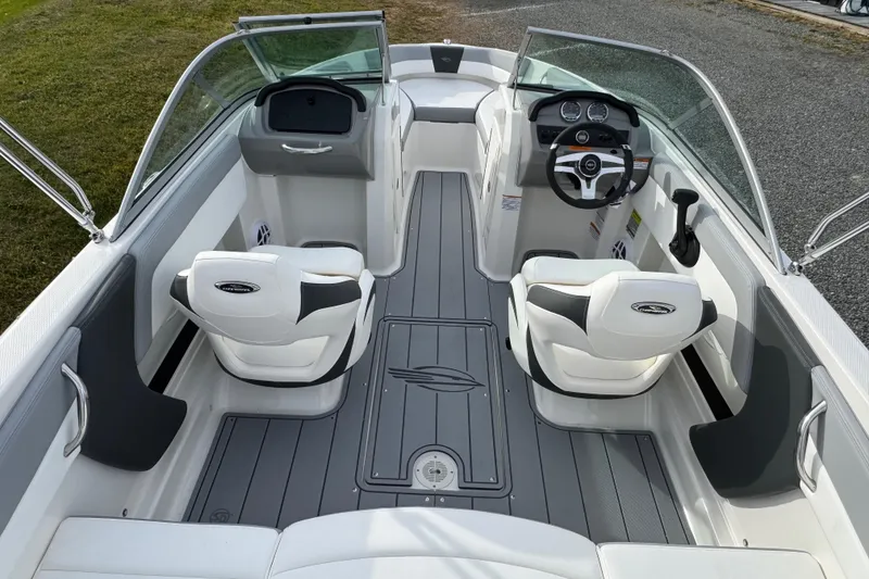 Slide: The Image of 2026 Chaparral 19 SSi OB boat interior with sleek seating and modern dashboard design. - 9