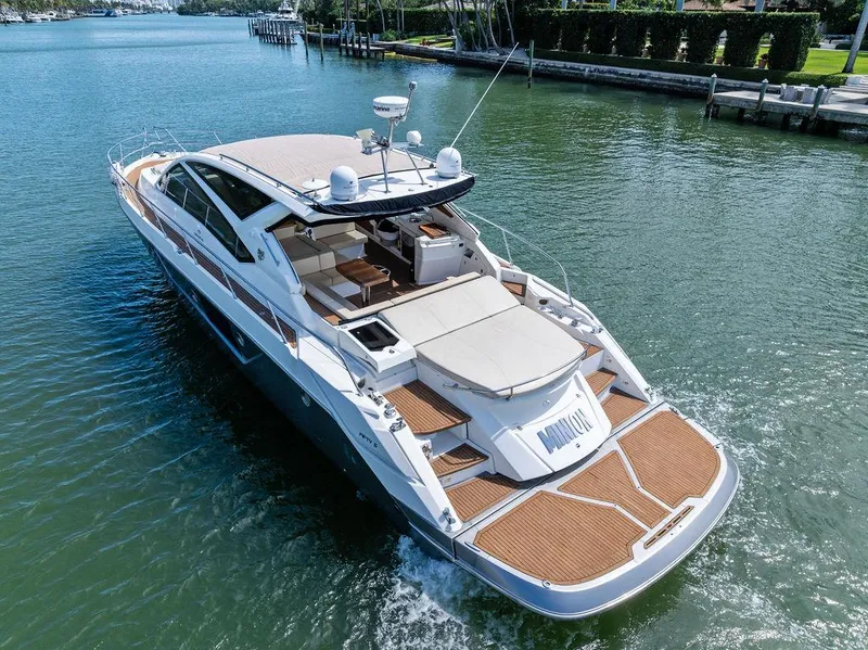 Slide: The Image of Luxury 2014 Cranchi 56 HT yacht cruising on a serene waterway. - 10