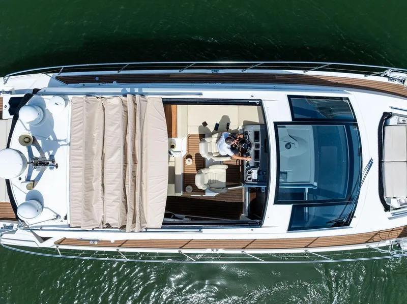 Slide: The Image of Aerial view of 2014 Cranchi 56 HT yacht on water, showcasing sleek design and spacious deck. - 15