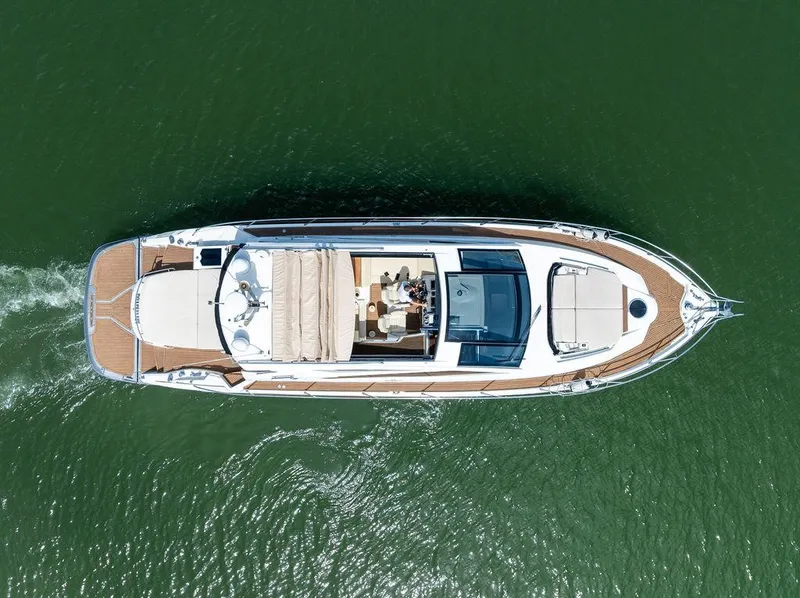 Slide: The Image of Overhead view of 2014 Cranchi 56 HT yacht cruising on green water. - 16