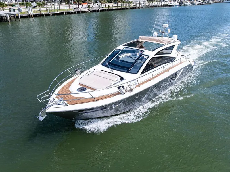 Slide: The Image of 2014 Cranchi 56 HT yacht cruising on a calm waterway. - 17