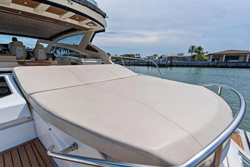 Slide: The Image of Luxury Cranchi 56 HT yacht with spacious sunbed, docked by waterfront homes, 2014 model. - 19
