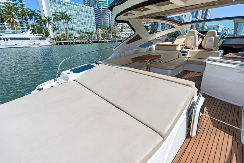 Slide: The Image of Luxurious 2014 Cranchi 56 HT yacht with spacious deck and seating, docked in a marina. - 20