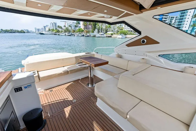 Slide: The Image of Luxurious 2014 Cranchi 56 HT yacht interior with spacious seating and scenic waterfront view. - 25