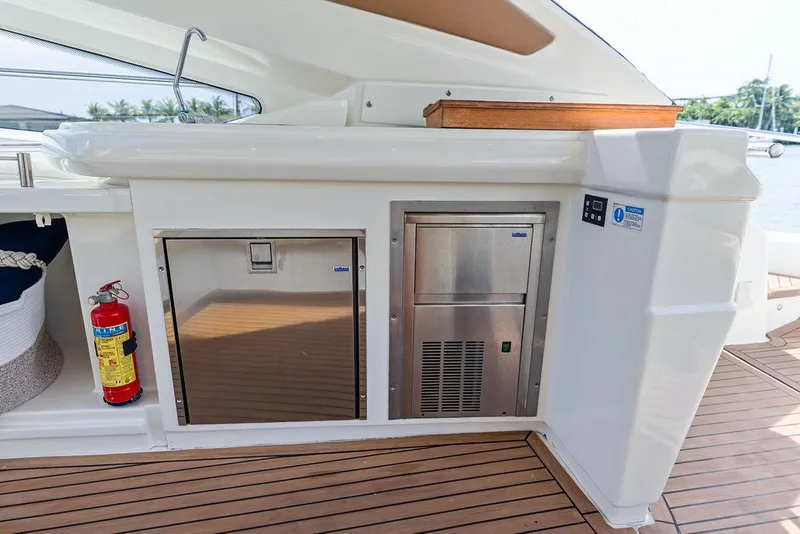 Slide: The Image of Outdoor kitchen area on 2014 Cranchi 56 HT yacht with stainless steel appliances and fire extinguisher. - 27