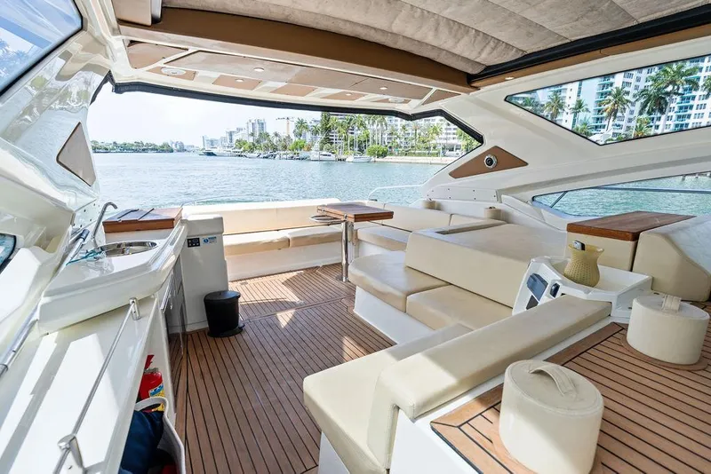 Slide: The Image of Luxurious 2014 Cranchi 56 HT yacht interior with elegant seating and scenic waterfront view. - 29