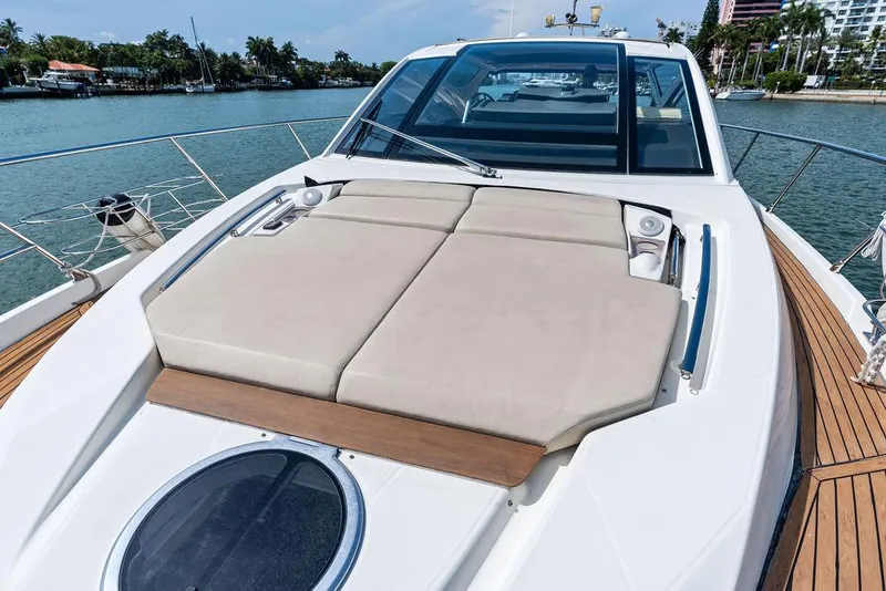Slide: The Image of Cranchi 56 HT 2014 yacht with sunbathing deck, docked by a scenic waterfront. - 33