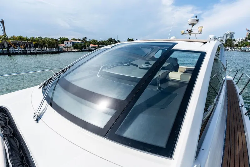 Slide: The Image of 2014 Cranchi 56 HT yacht with sleek design, docked by waterfront homes. - 34