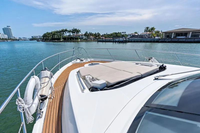 Slide: The Image of 2014 Cranchi 56 HT yacht with sun deck, cruising near waterfront homes. - 35