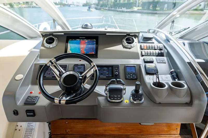 Slide: The Image of Helm of 2014 Cranchi 56 HT yacht with modern navigation controls and steering wheel. - 40