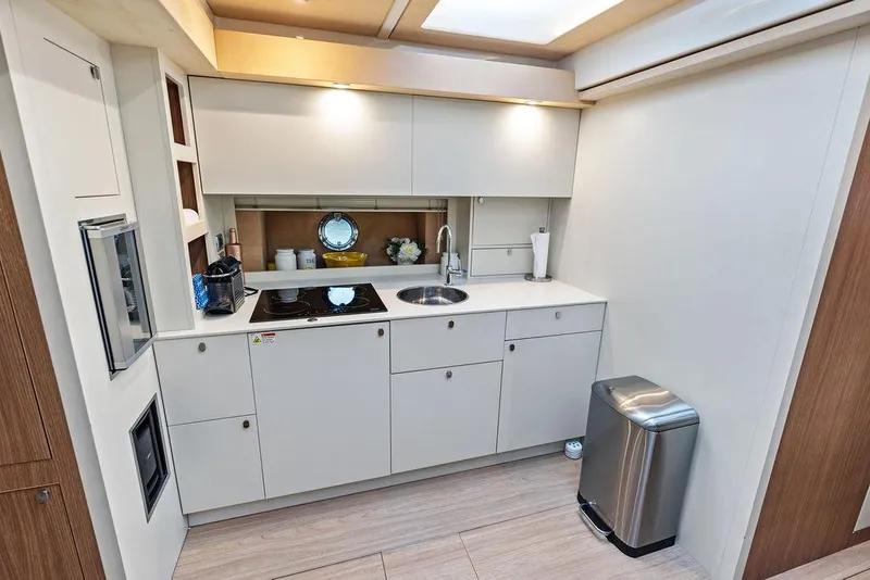 Slide: The Image of Modern kitchen interior on 2014 Cranchi 56 HT yacht, featuring sleek cabinetry and appliances. - 46