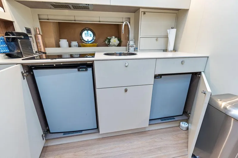 Slide: The Image of Modern kitchen area in 2014 Cranchi 56 HT yacht with dual fridges and sleek cabinetry. - 47