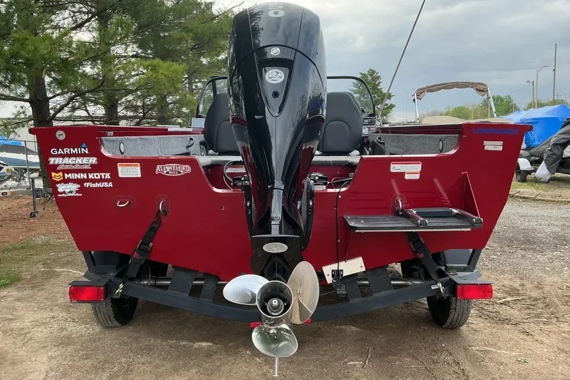 Slide: The Image of 2020 Tracker Targa V-18 WT boat with outboard motor, parked outdoors. - 14