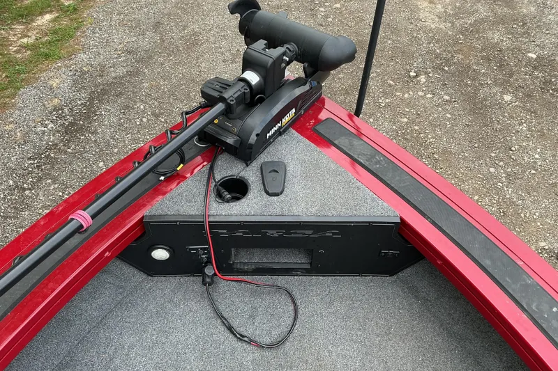 Slide: The Image of Red 2020 Tracker Targa V-18 WT boat with trolling motor on gravel surface. - 7