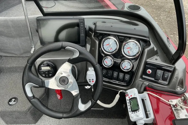 Slide: The Image of 2020 Tracker Targa V-18 WT boat dashboard with steering wheel and gauges. - 8