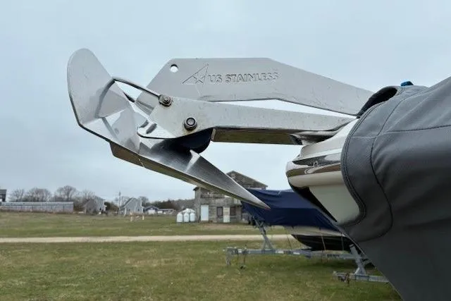 Slide: The Image of Stainless steel anchor on 2015 Edgewater 245CC boat, parked on grassy area. - 11