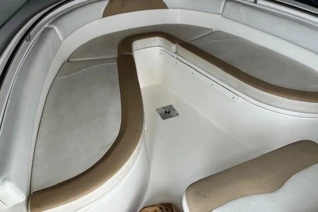 Slide: The Image of Interior view of a 2015 Edgewater 245CC boat, featuring cushioned seating. - 15