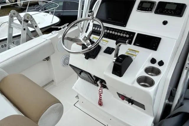 Slide: The Image of 2015 Edgewater 245CC boat cockpit with steering wheel and control panel. - 17