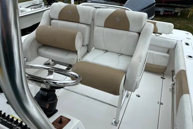 Slide: The Image of 2015 Edgewater 245CC boat interior with dual cushioned seats and steering wheel. - 22