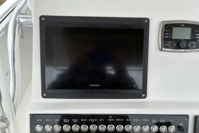 Slide: The Image of Control panel of 2015 Edgewater 245CC boat with Garmin display and switches. - 25