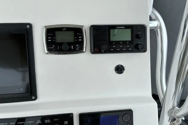 Slide: The Image of Control panel of a 2015 Edgewater 245CC boat with Garmin and Polk electronics. - 26