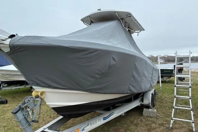 Slide: The Image of Covered 2015 Edgewater 245CC boat on trailer with ladder nearby. - 27