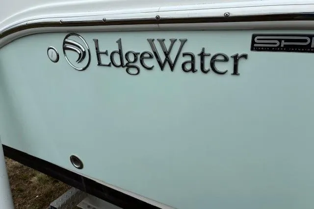 Slide: The Image of EdgeWater 245CC 2015 boat logo on white hull. - 5