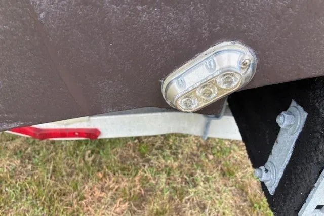 Slide: The Image of LED light on 2015 Edgewater 245CC boat hull, near trailer. - 8