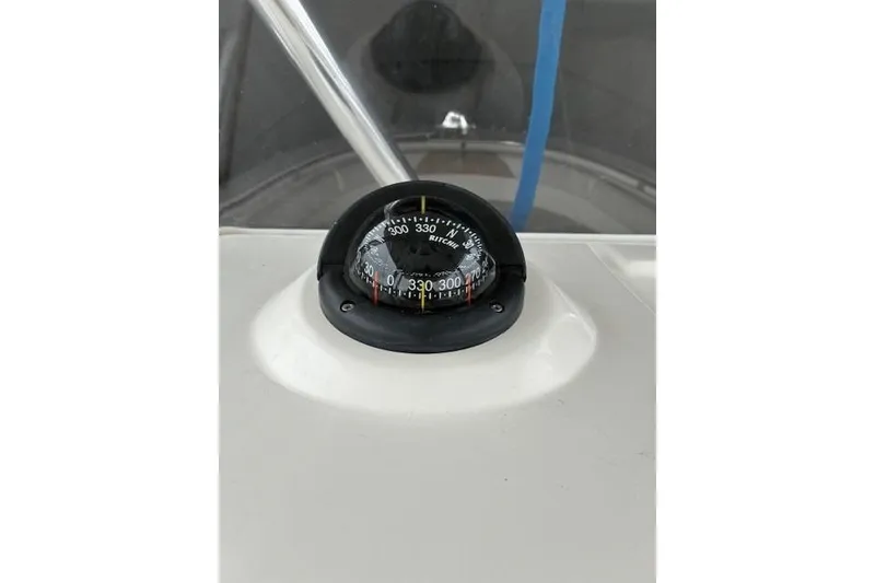 Slide: The Image of Compass on 2015 Edgewater 245CC boat dashboard, displaying navigation directions. - 9