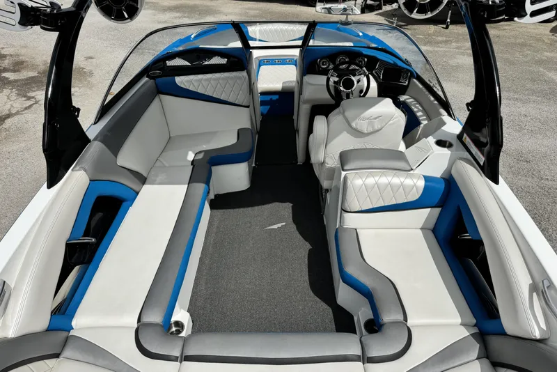 Slide: The Image of 2013 Tigé RZ4 boat interior with white and blue seating, sleek design. - 10