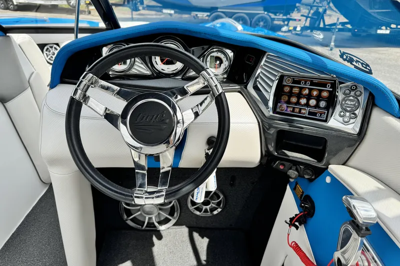 Slide: The Image of 2013 Tigé RZ4 boat dashboard with steering wheel and digital display. - 12