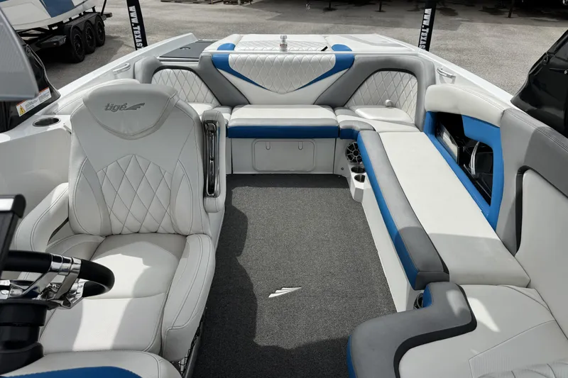 Slide: The Image of Interior of a 2013 Tigé RZ4 boat with white and blue seating. - 15