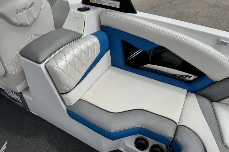 Slide: The Image of 2013 Tigé RZ4 boat interior with white, blue, and gray cushioned seating. - 16