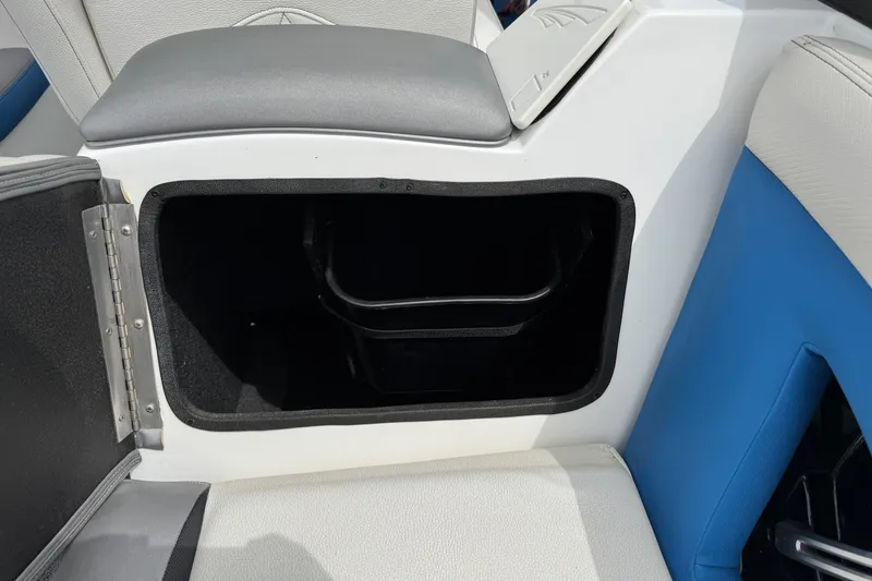 Slide: The Image of Open storage compartment in 2013 Tigé RZ4 boat interior. - 17