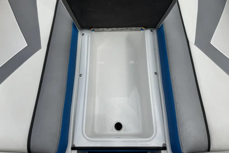 Slide: The Image of 2013 Tigé RZ4 boat interior storage compartment with gray and blue upholstery. - 18