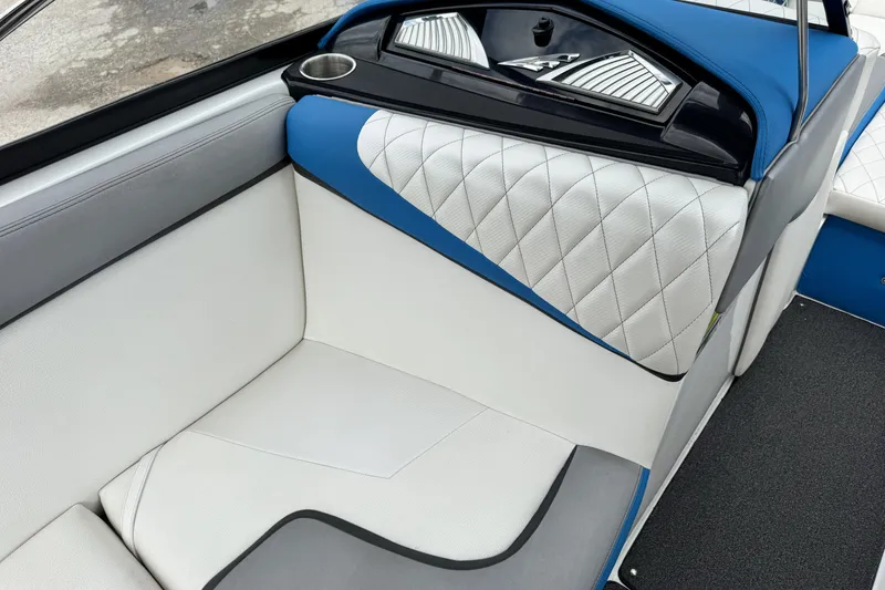 Slide: The Image of 2013 Tigé RZ4 boat interior with blue and white quilted seating. - 20