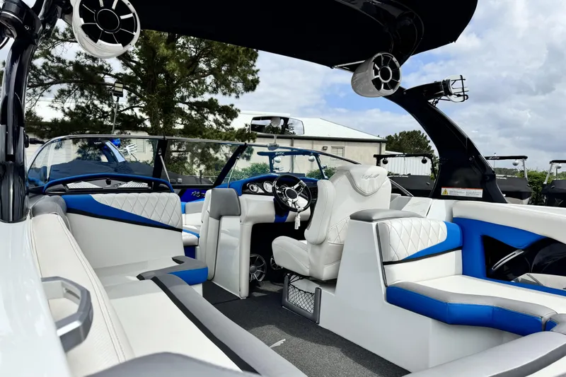 Slide: The Image of Interior of 2013 Tigé RZ4 boat with white and blue seating, modern design. - 8
