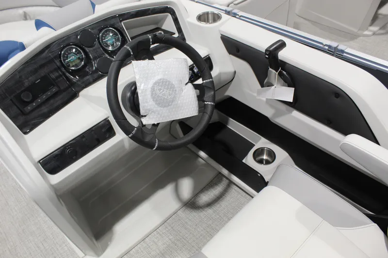 Slide: The Image of Interior of 2026 Avalon 2185 25 LSZ CRB boat, featuring steering wheel and dashboard controls. - 3