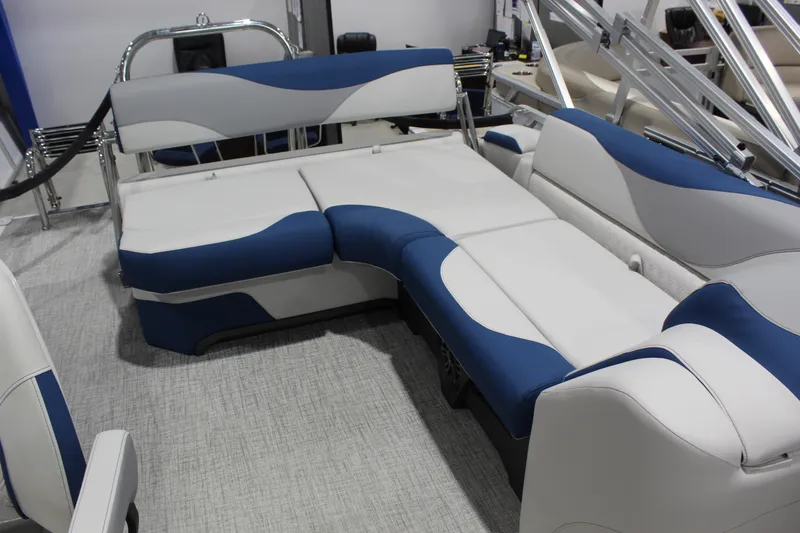 Slide: The Image of Luxurious seating on 2026 Avalon 2185 25 LSZ CRB pontoon boat, featuring blue and white upholstery. - 5